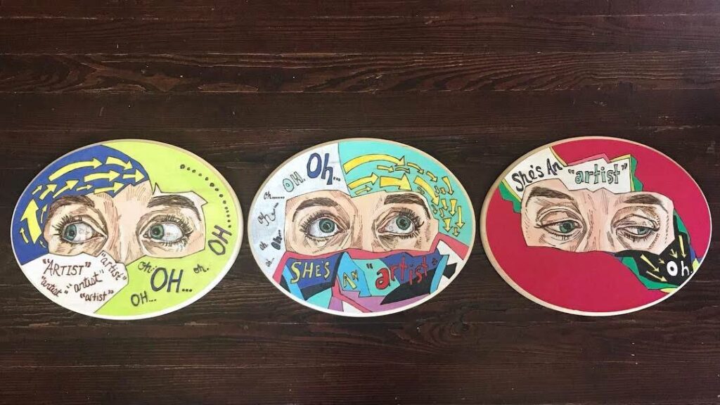 Three plates with eyes and a face painted on them.