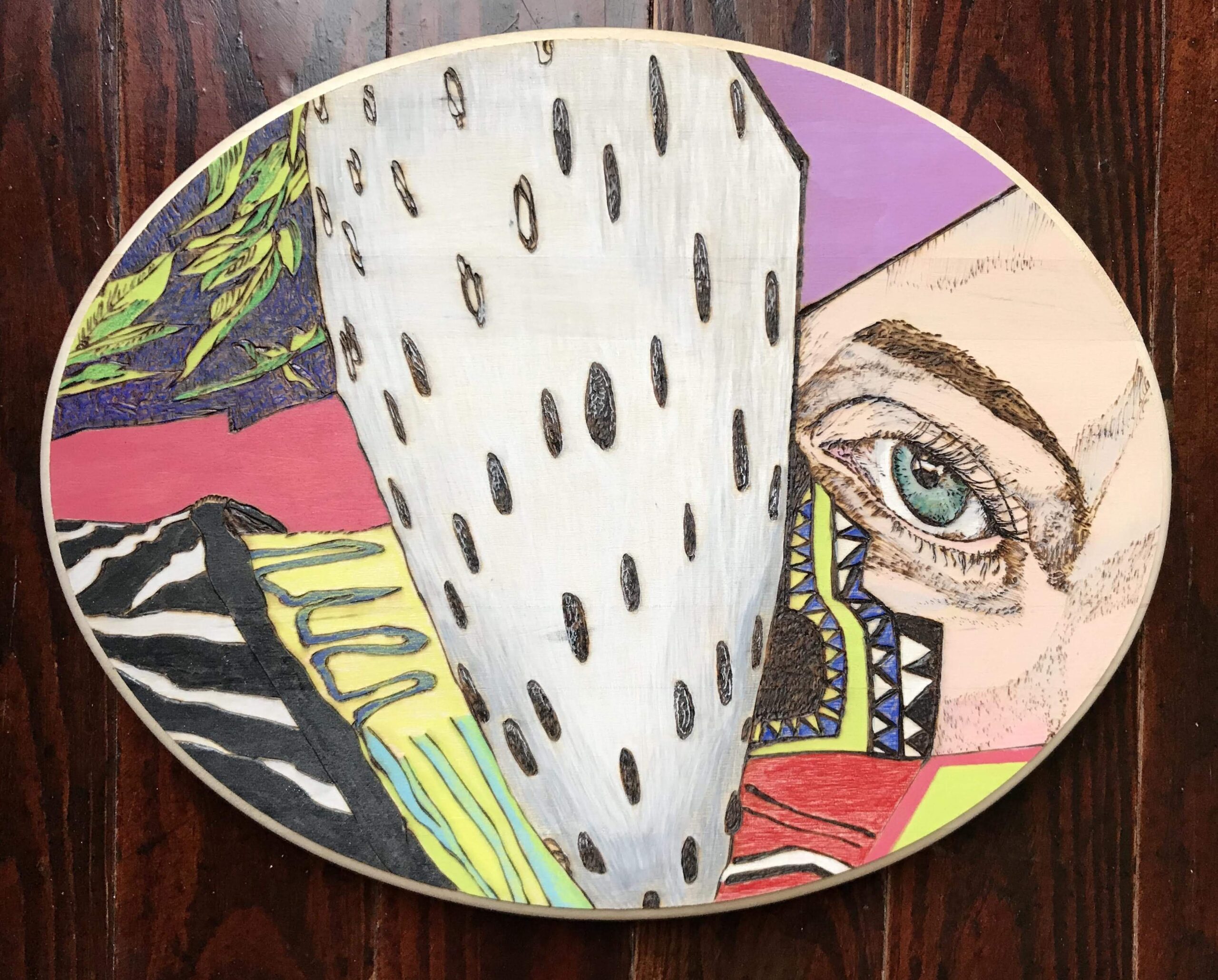 A painting of an eye and a face on a plate.