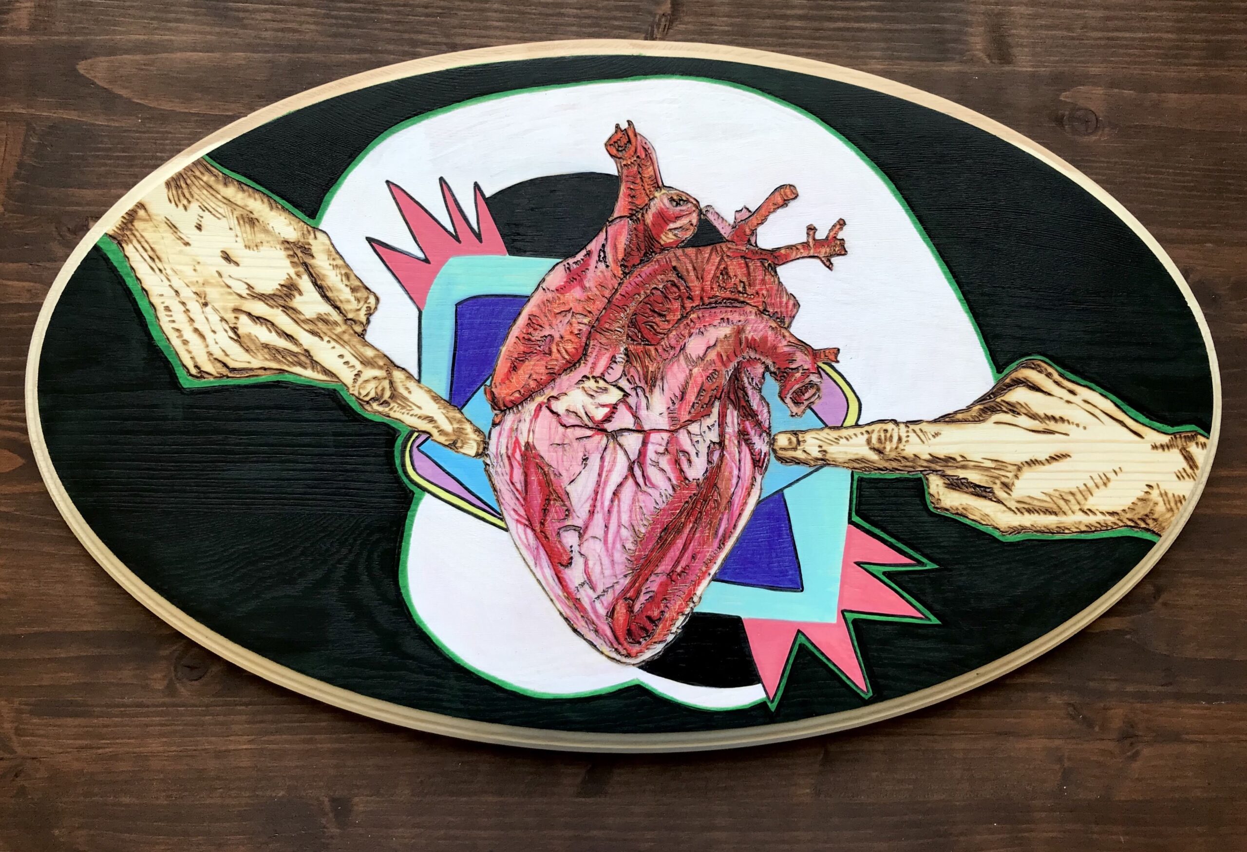 A painting of a heart on the side of a skateboard.