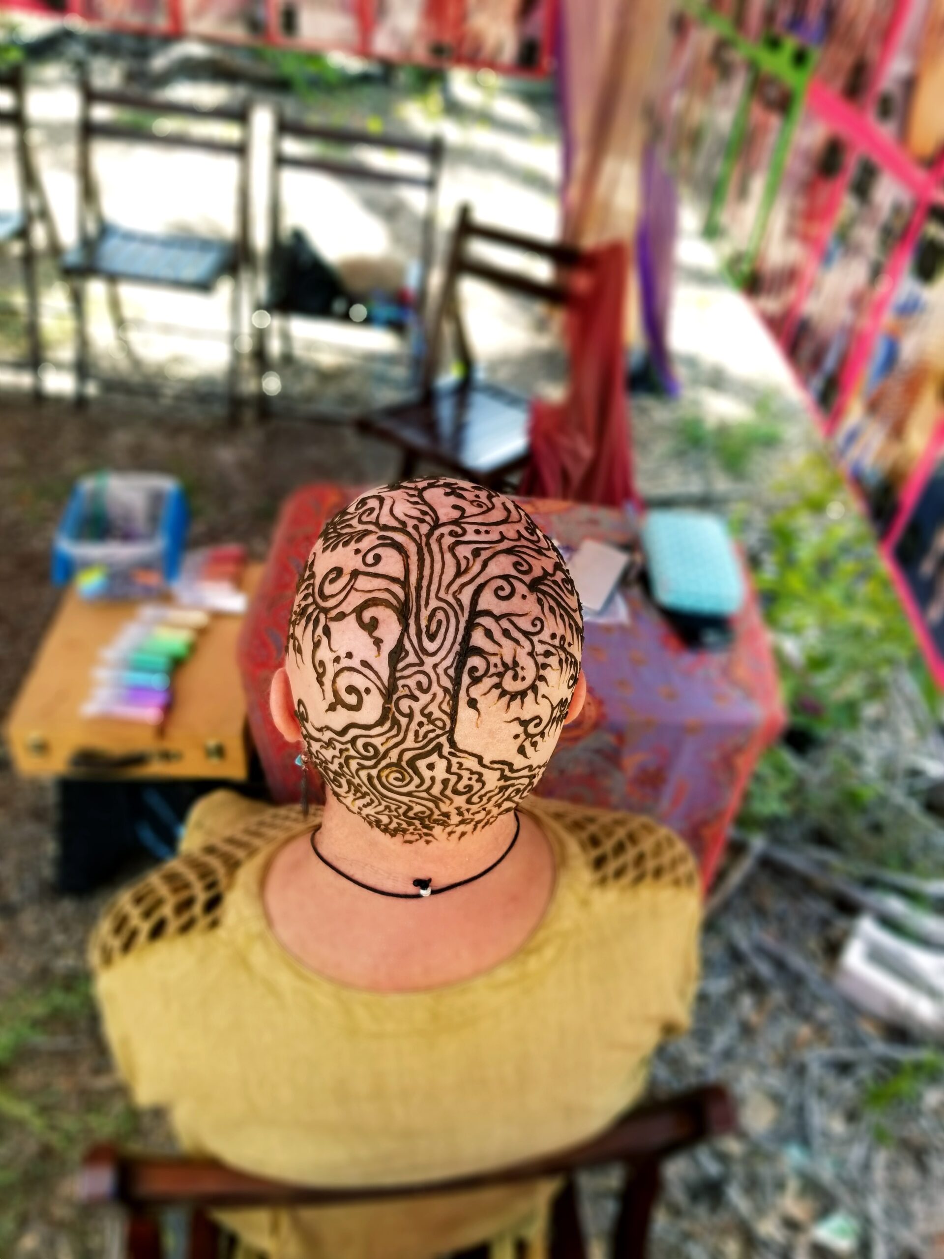 A woman with henna designs on her head.