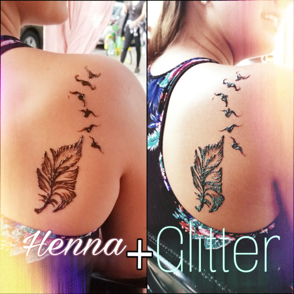 A woman with henna and glitter on her shoulder.