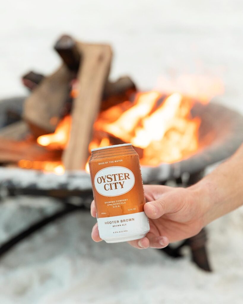 A person holding up a can of oyster city sauce.