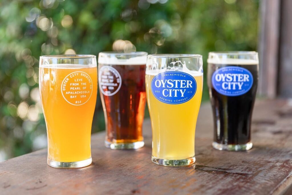 A group of four glasses filled with different beers.