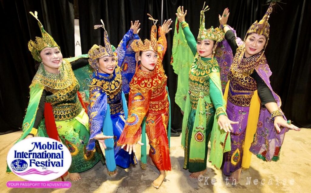 A group of women in colorful outfits standing next to each other.