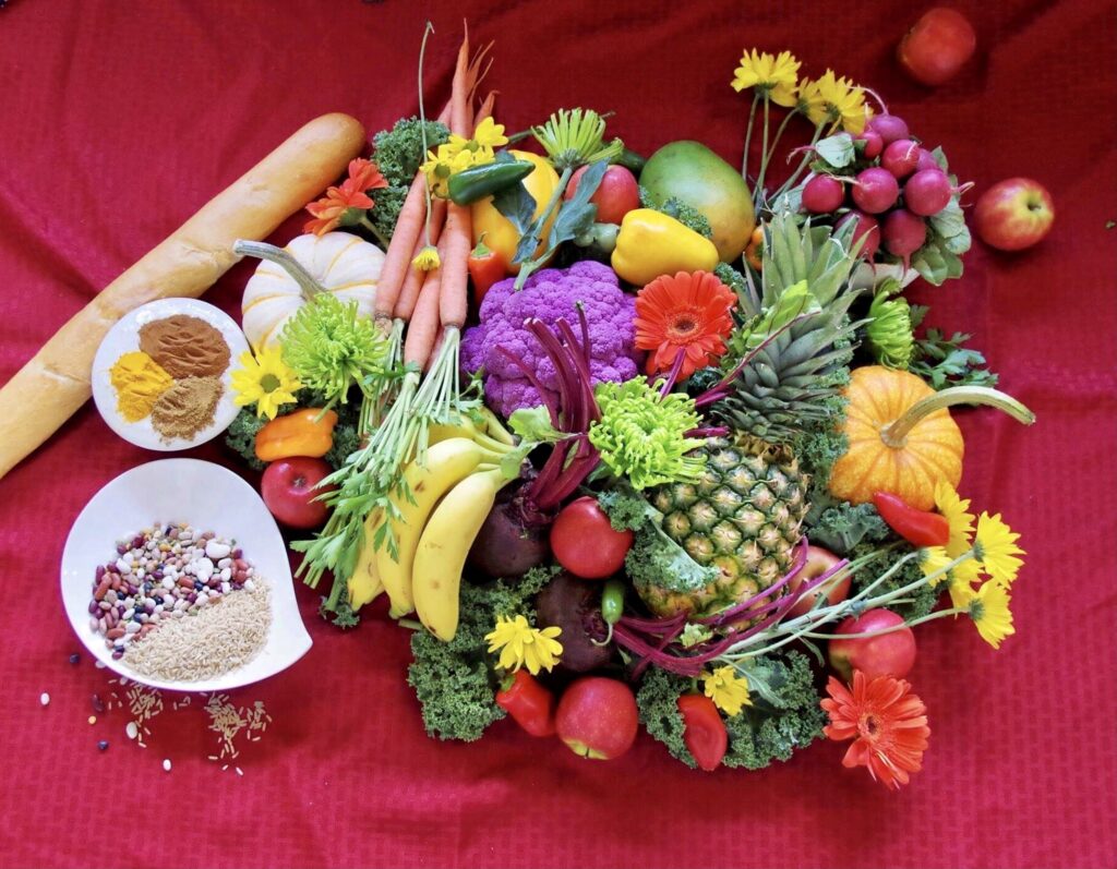 A red table with fruit and vegetables on it