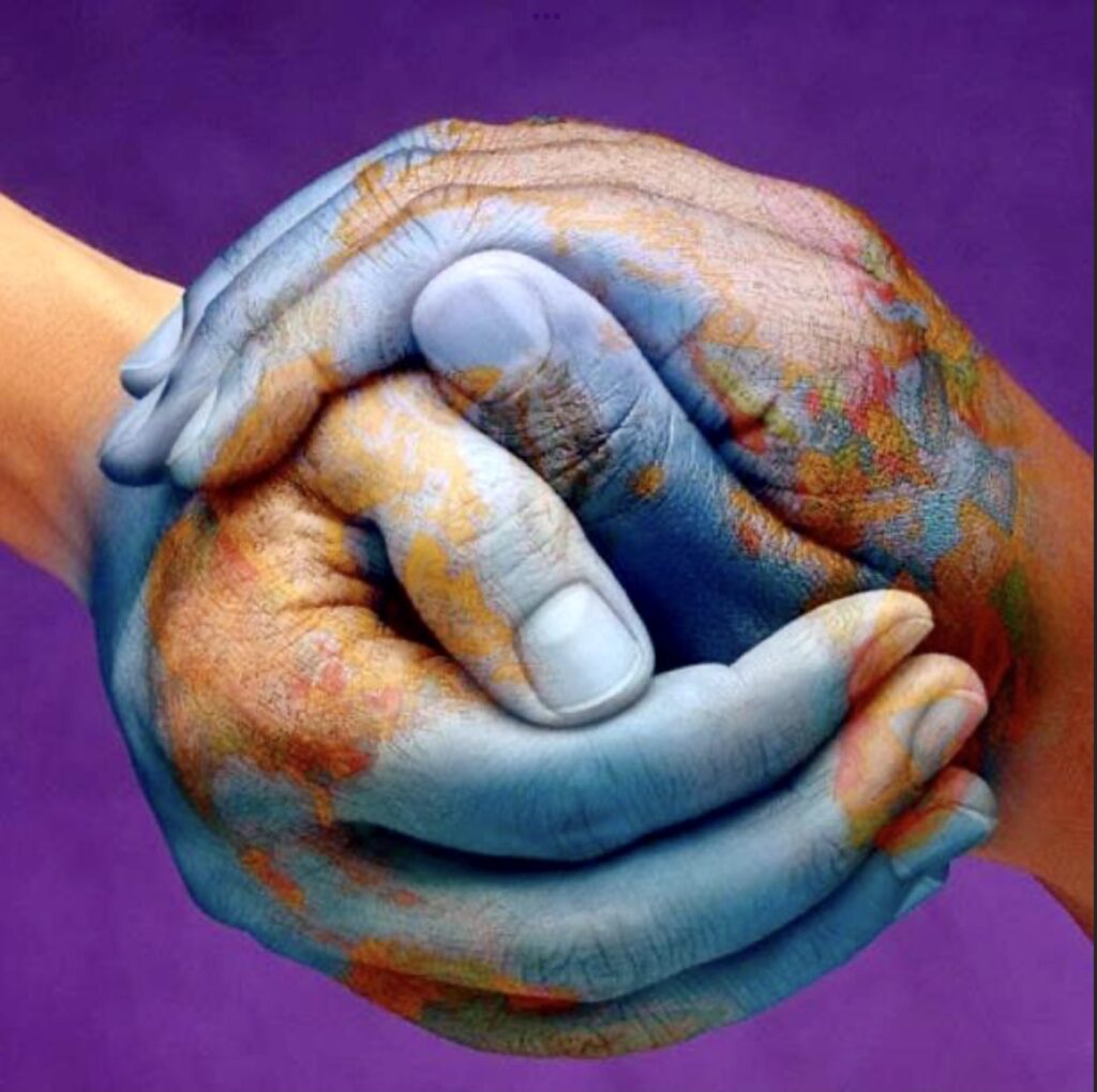 Two hands holding each other with a world map painted on them.