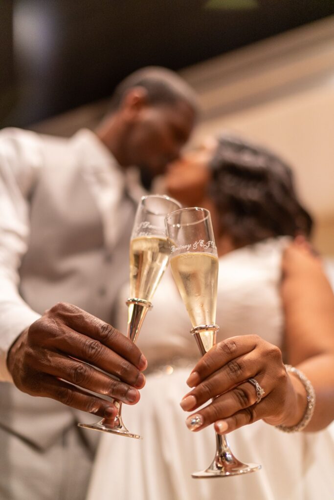 A man and woman holding champagne flutes in their hands.