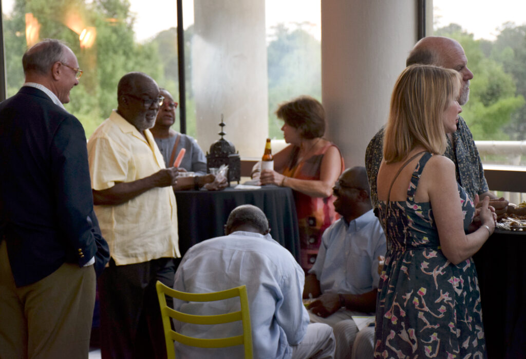 A group of people standing around a table.