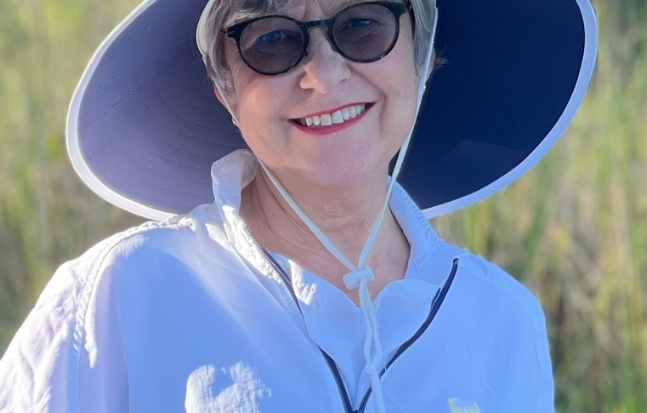 A woman wearing sunglasses and a hat.